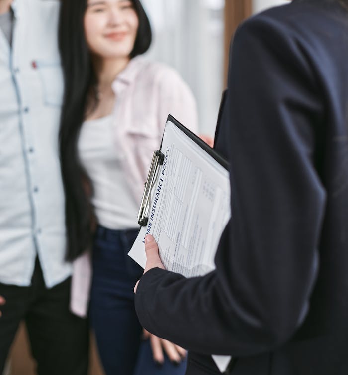 Professional meeting discussion with focus on business documents held by a woman.