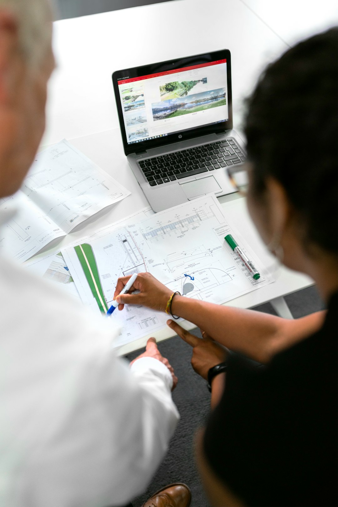 services-05 Female civil engineer discusses flood risk management plans with colleague